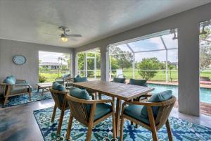 a dining room with a table and chairs and a pool at GRH14276 - Charlotte Harbor Area - 3 Bed 2 Baths Villa in Punta Gorda Isles
