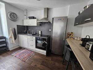 a kitchen with a stove and a counter top at Chez Sandrine in Angoulême +22 photos