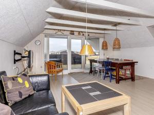 a living room with a couch and a table at 6 person holiday home in Thisted-By Traum in Torsted