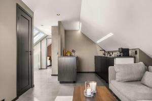 a living room with a couch and a table at Stylish Loft on Bakaroy in Haugesund
