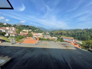 a view of a city from the roof of a building at Una finestra sul mondo! in Biella
