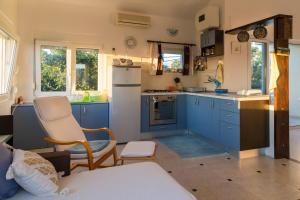 a kitchen with blue cabinets and a white refrigerator at Apartment Vanilla in Borovići