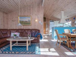 a living room with a couch and a table at 8 person holiday home in Glesborg-By Traum in Glesborg