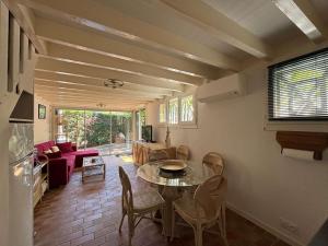 a living room with a table and chairs at Vacances au lac ! in Biscarrosse