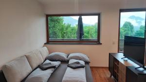 a living room with a couch and a window at Apartment Dengg in Kössen