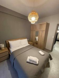 a bedroom with a bed with two towels on it at Kairos luxury apartments Fanari 2 in Fanárion +25 photos