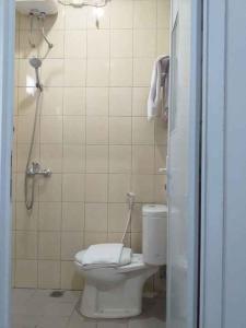 a bathroom with a toilet and a shower stall at Daima Syariah Mansion in Jakarta