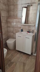 a bathroom with a toilet and a sink and a mirror at Villa Fede&Edo in Surbo +67 photos