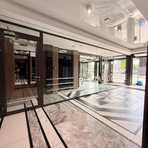 a lobby of a building with glass windows at Apartament GJ PLAZA II in Kielce
