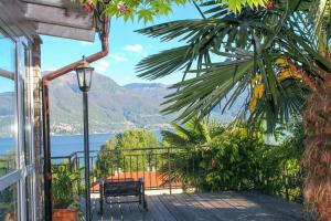 a balcony with a bench and a view of the water at Casa Laluni in Porto Valtravaglia
