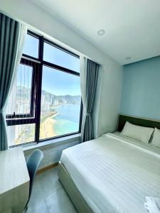 a bedroom with a bed and a view of the ocean at Seahome Beachfront Apartment - Mường Thanh Viễn Triều Nha Trang in Nha Trang +32 photos
