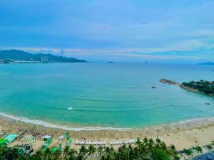 a view of a beach with people in the water at Seahome Beachfront Apartment - Mường Thanh Viễn Triều Nha Trang in Nha Trang