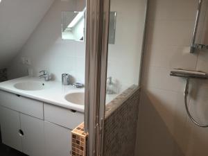 a white bathroom with a sink and a mirror at Gîtes du Montois in Genech +19 photos