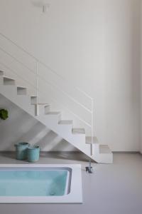a bathroom with a sink and a staircase at Palazzo Console in Lecce +116 photos