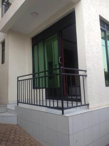 a balcony with a red door on a building at Apartment in Kigali