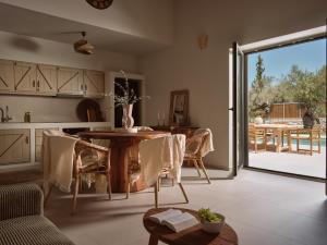 a kitchen and dining room with a table and a patio at Conte Maris IV in Tragaki