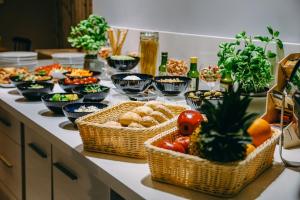 a table with baskets of food and bowls of food at Willa Marianna in Lądek-Zdrój