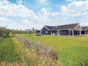 a house with a playground in front of a yard at Luxury Spa Retreat in Hurup - By Traum Ferienwohnungen in Hadsund