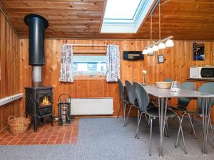 a dining room with a table and a stove at 5 person holiday home in Hejls-By Traum in Hejls