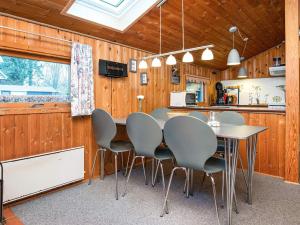 a kitchen with a table and chairs in a room at 5 person holiday home in Hejls-By Traum in Hejls