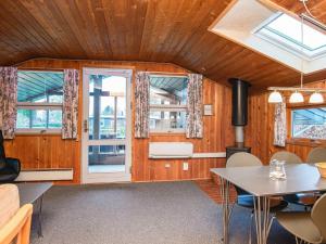 a living room with a table and chairs and windows at 5 person holiday home in Hejls-By Traum in Hejls