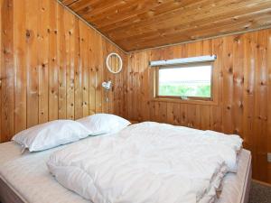 a bed in a wooden room with a window at 5 person holiday home in Hejls-By Traum in Hejls +16 photos