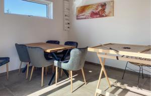 a dining room with a wooden table and chairs at 4 Bedroom Amazing Home In Fredericia in Fredericia