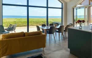 a living room with a couch and a table and chairs at 4 Bedroom Amazing Home In Fredericia in Fredericia