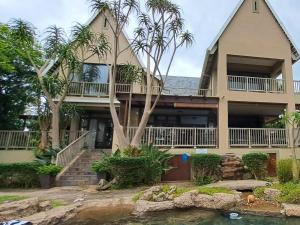 a large house with palm trees in front of it at 29 on St James Guest Lodge in Durban