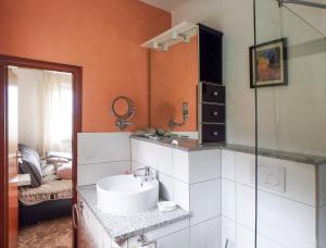 a bathroom with a sink and a glass shower at Casa Laluni in Porto Valtravaglia +11 photos