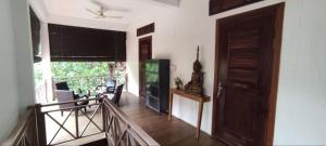 a room with a staircase and a door and a balcony at Banksy's Siem Reap in Phumĭ Réach Born
