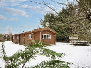 a small house with snow on the ground at 6 person holiday home in Fårvang-By Traum in Fårvang