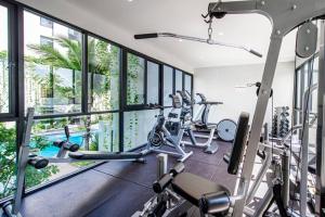 a gym with treadmills and elliptical machines at Diamond Condo by VС in Bang Tao Beach +14 photos