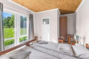a bedroom with two beds and a large window at Fazenda Akwa Baseini in Solotvyno