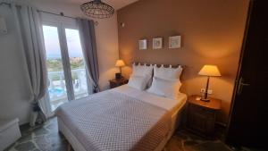 a bedroom with a bed and a large window at Mediterranean Villa Megara in Megara +73 photos