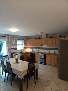a kitchen with a table and chairs and a kitchen with wooden cabinets at Beautiful home kenmare in Kenmare