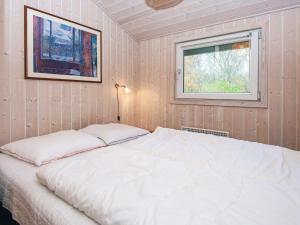a bed in a room with a window at 6 person holiday home in Hemmet-By Traum in Falen