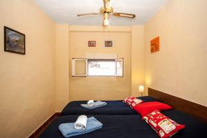 Habitación pequeña con 2 camas y ventana en Dos Alamos B&B, en Álora