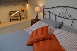 a bedroom with a bed with a mirror on the wall at A Casa di Nonna Linda B&B in Senigallia