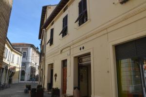 an empty street with a building and a store at A Casa di Nonna Linda B&B in Senigallia