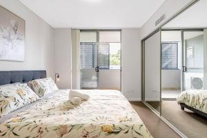 a bedroom with a large bed and windows at 11B Abnb-Style Charming 12 Mins Walk Train STA Free parking2BR in Bankstown +23 photos