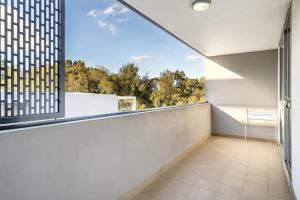 an empty room with a large window and white walls at 11B Abnb-Style Charming 12 Mins Walk Train STA Free parking2BR in Bankstown