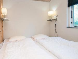 two white beds in a room with two lamps at 2 person holiday home in Tarm in Fjerbæk