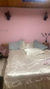 a large white bed in a room with a pink wall at HABITACIONES moom living boutique in Chía +24 photos