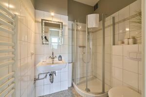 a bathroom with a sink and a shower and a toilet at Haus Sonnenhof Sonnenhof 10 - Joni in Kellenhusen