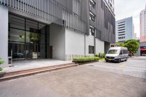 a van parked in a parking lot next to a building at Soho Apartment Central in District 1 in Ho Chi Minh City