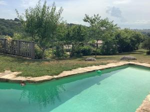 a swimming pool in a yard with trees at Chambre d hôtes GRANAL in Saint-Julien-Gaulène +2 photos