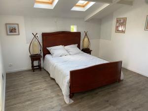 a bedroom with a large bed in a room with skylights at Maison avec jardin, à deux pas de Paris in Deuil-la-Barre