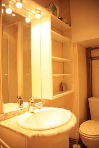 a bathroom with a sink and a toilet and a mirror at Saint Michel Notre Dame in Paris +8 photos