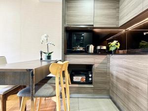 Una cocina con una mesa y sillas de madera. en Klass Langsuan Condo, en Bangkok